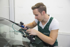 stock-photo-28902764-windscreen-repair-by-glazier-in-garage-after-stone-chipping-damage